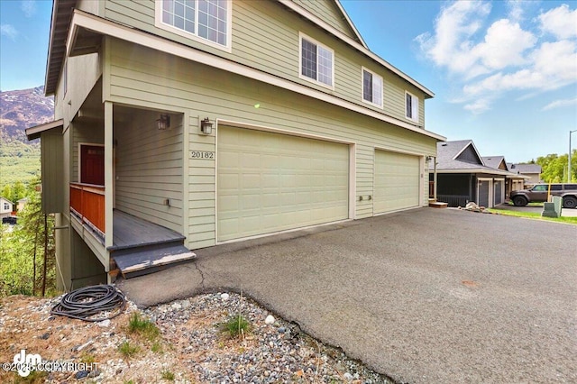20182 Eagles Nest Ct # 5B, Eagle River, AK 99577 - view of home's exterior with a garage and asphalt driveway