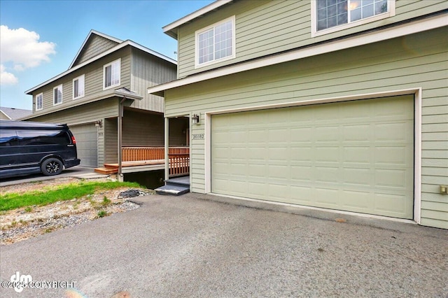 20182 Eagles Nest Ct # 5B, Eagle River, AK 99577 - view of front of home featuring a garage and asphalt driveway