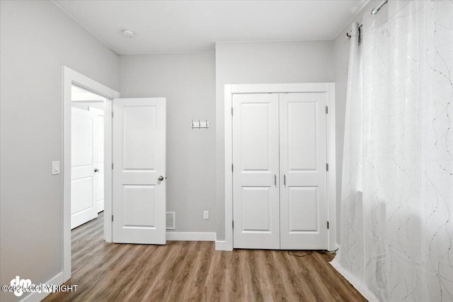 1521 N Kerry Ln, Wasilla, AK 99654 - unfurnished bedroom with wood finished floors and a closet