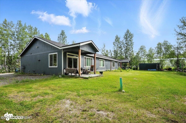 1521 N Kerry Ln, Wasilla, AK 99654 - back of property with a patio area and a yard