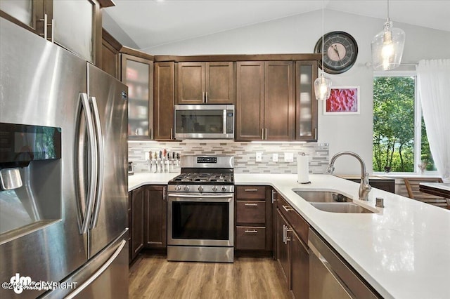 1521 N Kerry Ln, Wasilla, AK 99654 - kitchen featuring appliances with stainless steel finishes, lofted ceiling, light countertops, wood finished floors, and decorative light fixtures