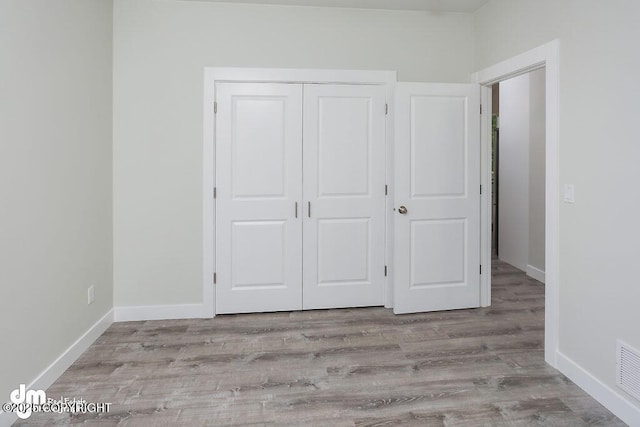 1521 N Kerry Ln, Wasilla, AK 99654 - unfurnished bedroom featuring a closet and wood finished floors