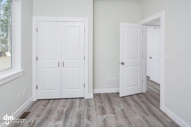 1521 N Kerry Ln, Wasilla, AK 99654 - unfurnished bedroom featuring wood finished floors and a closet