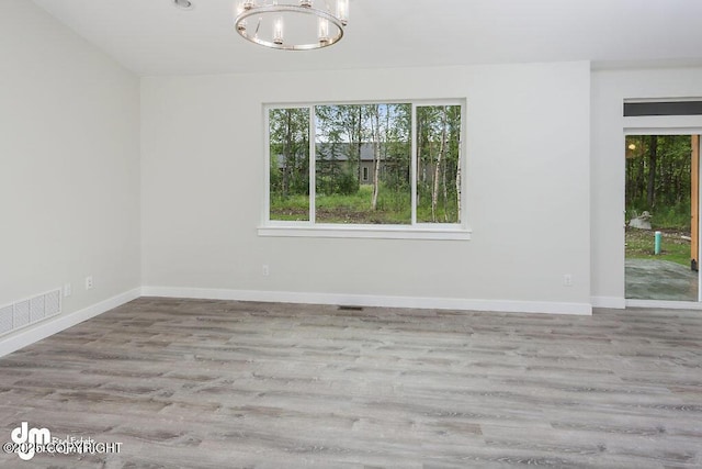 1521 N Kerry Ln, Wasilla, AK 99654 - unfurnished room with a chandelier and wood finished floors