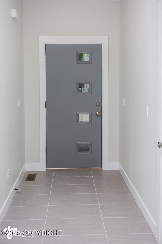 1521 N Kerry Ln, Wasilla, AK 99654 - doorway with tile patterned flooring and baseboards