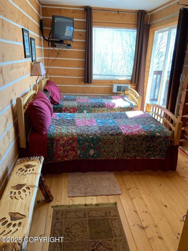 2525 Sterling Hwy, Homer, AK 99603 - bedroom featuring hardwood / wood-style flooring and a wall mounted air conditioner