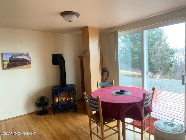 2525 Sterling Hwy, Homer, AK 99603 - dining area with light wood-style floors and a wood stove