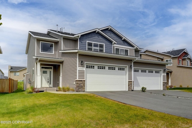 8784 Dry Creek Loop # 40A, Anchorage, AK 99502 - view of front of house with an attached garage, stone siding, and driveway