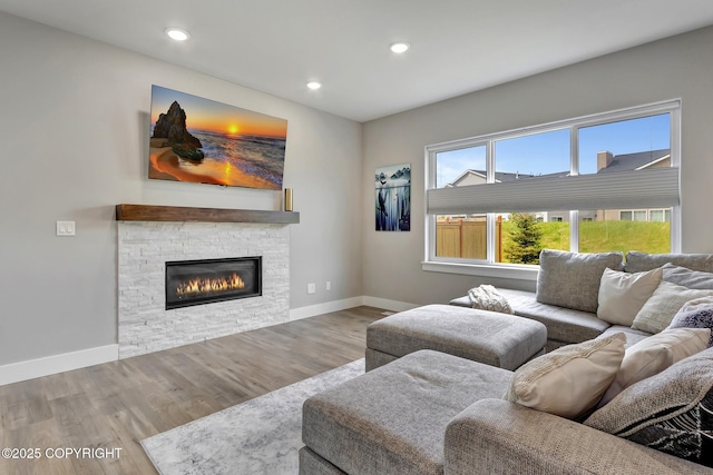 8784 Dry Creek Loop # 40A, Anchorage, AK 99502 - living room featuring wood finished floors, baseboards, a stone fireplace, and recessed lighting