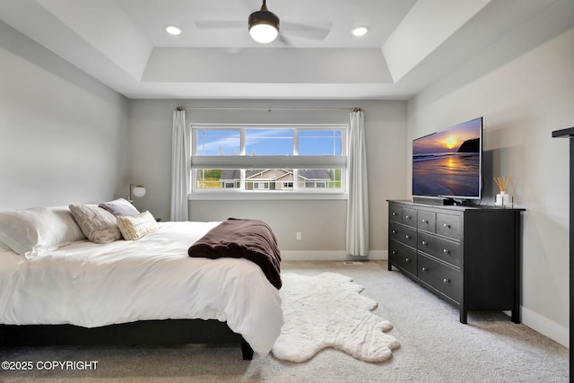 8784 Dry Creek Loop # 40A, Anchorage, AK 99502 - bedroom featuring a tray ceiling, baseboards, and light carpet