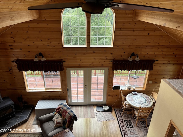 41873 S Running River Dr, Remote, AK 99676 - living area with vaulted ceiling, a ceiling fan, french doors, a wood stove, and wood finished floors