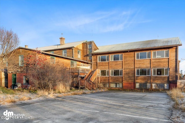 147 E Pioneer Ave, Homer, AK 99603 - back of property with metal roof, a chimney, and stairs