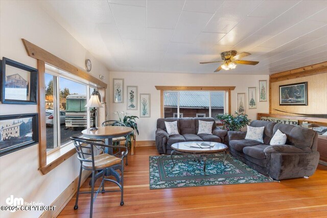 147 E Pioneer Ave, Homer, AK 99603 - living room featuring wood finished floors, a ceiling fan, and baseboards
