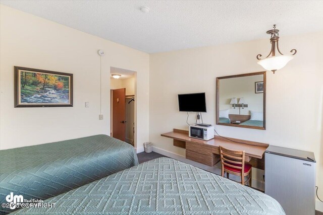 147 E Pioneer Ave, Homer, AK 99603 - bedroom with baseboards and a textured ceiling