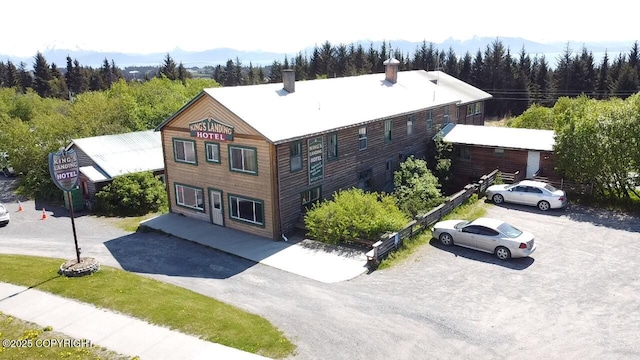 147 E Pioneer Ave, Homer, AK 99603 - view from above of property with a heavily wooded area and a mountainous background