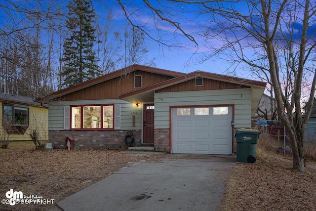 1920 E 56th Ave, Anchorage, AK 99507 - view of front facade featuring asphalt driveway and an attached garage
