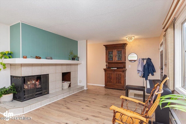 1920 E 56th Ave, Anchorage, AK 99507 - living area with a textured ceiling, wood finished floors, a fireplace, and baseboards