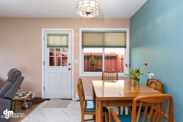 1920 E 56th Ave, Anchorage, AK 99507 - dining area with a baseboard heating unit, healthy amount of natural light, and a chandelier