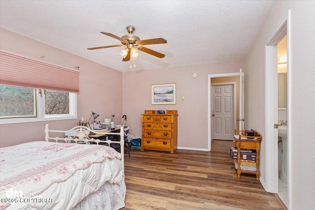 1920 E 56th Ave, Anchorage, AK 99507 - bedroom with wood finished floors, a textured ceiling, a ceiling fan, and baseboards