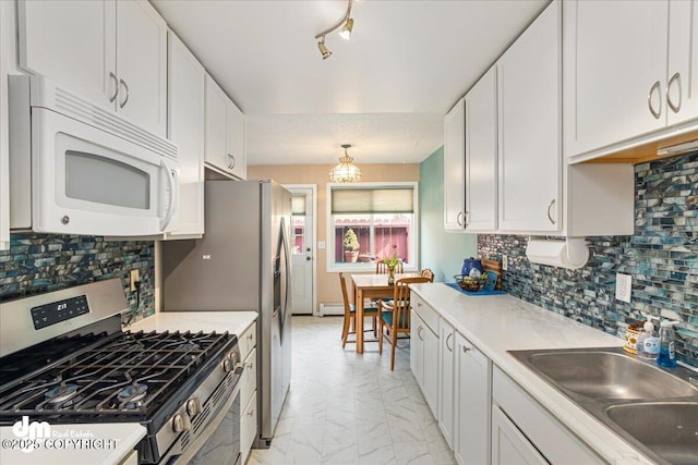 1920 E 56th Ave, Anchorage, AK 99507 - kitchen with appliances with stainless steel finishes, light marble finish floors, a sink, and white cabinetry
