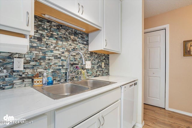 1920 E 56th Ave, Anchorage, AK 99507 - kitchen with dishwasher, a sink, white cabinets, and light countertops