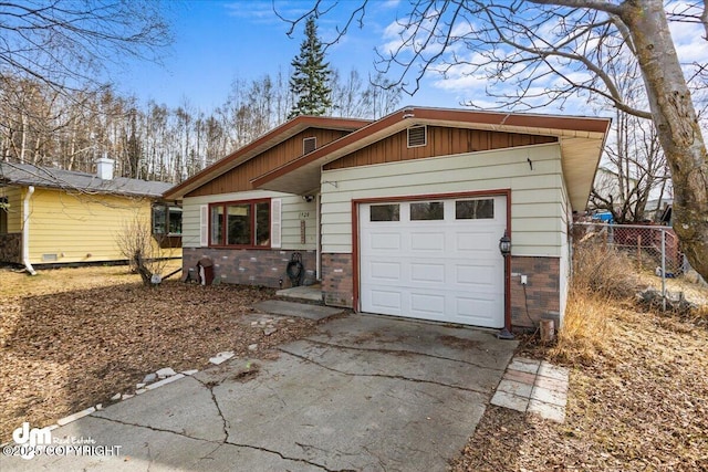 1920 E 56th Ave, Anchorage, AK 99507 - view of front of home with brick siding, a garage, and asphalt driveway