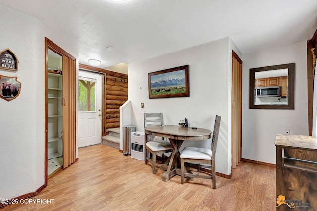 704 S Freeman Way, Big Lake, AK 99623 - dining room with light wood-style floors, rustic walls, baseboards, and stairway