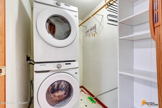 704 S Freeman Way, Big Lake, AK 99623 - laundry room with stacked washing machine and dryer and baseboards