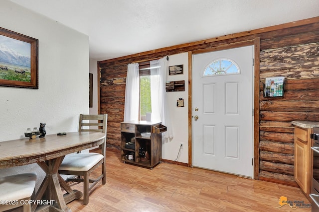 704 S Freeman Way, Big Lake, AK 99623 - entryway with healthy amount of natural light, light wood-style floors, and log walls