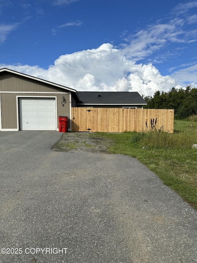 991 E Sue Ln Unit 1D, Wasilla, AK 99654 - view of side of home with driveway and a garage