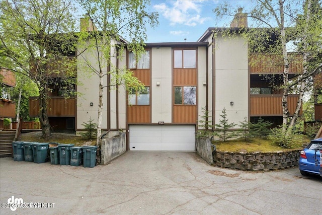 7341 Huntsmen Cir Unit 19C, Anchorage, AK 99518 - view of property with an attached garage and driveway