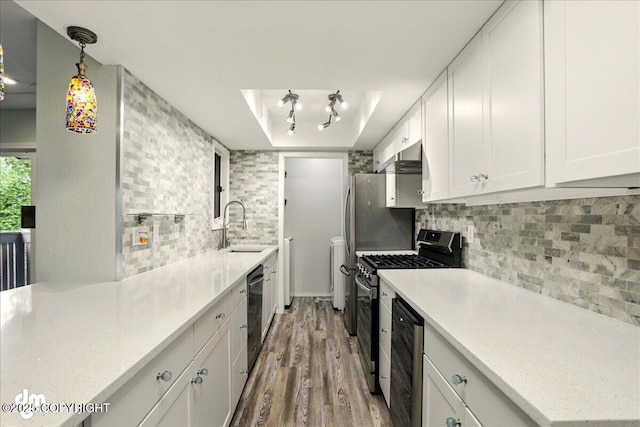7341 Huntsmen Cir Unit 19C, Anchorage, AK 99518 - kitchen featuring stainless steel range with gas cooktop, a sink, light wood-type flooring, tasteful backsplash, and white cabinetry