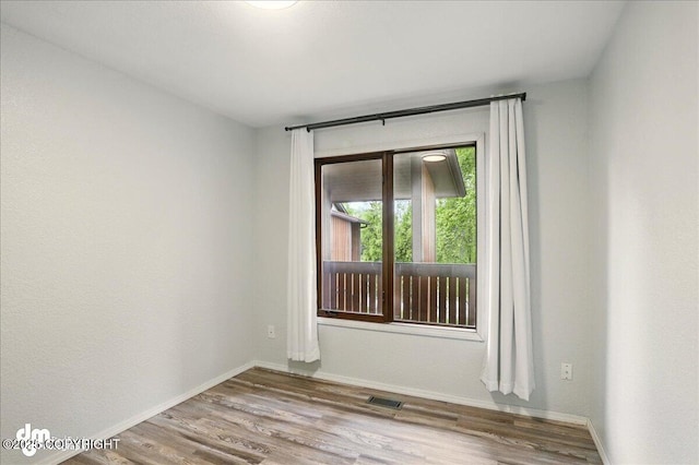 7341 Huntsmen Cir Unit 19C, Anchorage, AK 99518 - spare room with wood finished floors and baseboards