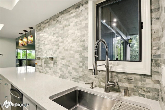 7341 Huntsmen Cir Unit 19C, Anchorage, AK 99518 - kitchen with a sink, tasteful backsplash, decorative light fixtures, light stone counters, and white cabinets