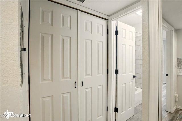 7341 Huntsmen Cir Unit 19C, Anchorage, AK 99518 - corridor featuring wood finished floors