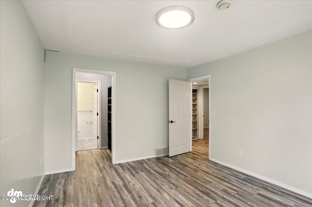7341 Huntsmen Cir Unit 19C, Anchorage, AK 99518 - unfurnished bedroom featuring wood finished floors and baseboards