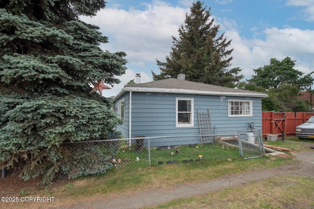 1403 W 34th Ave, Anchorage, AK 99503 - rear view of house with a gate and a chimney