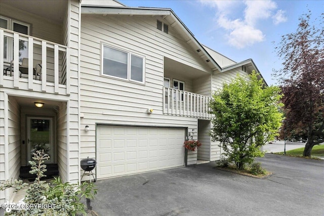 6716 Cutty Sark St, Anchorage, AK 99502 - view of front of property featuring a balcony, driveway, and a garage