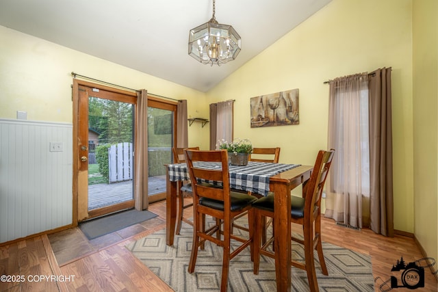 2100 N Palomino Ln, Palmer, AK 99645 - dining area featuring a chandelier, light wood-style flooring, vaulted ceiling, and wainscoting