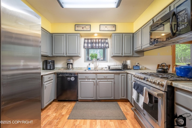 2100 N Palomino Ln, Palmer, AK 99645 - kitchen featuring black appliances, gray cabinets, a sink, and healthy amount of natural light