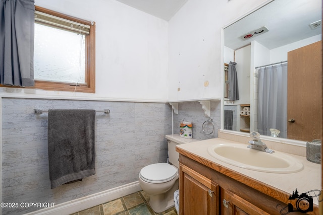 2100 N Palomino Ln, Palmer, AK 99645 - bathroom with toilet, vanity, wainscoting, and curtained shower