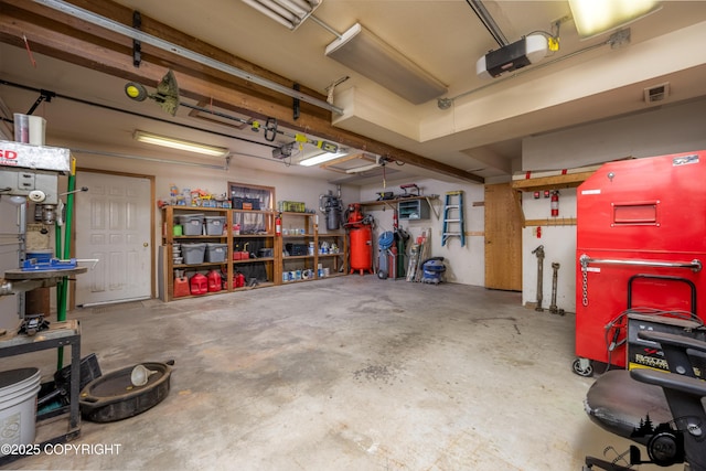 2100 N Palomino Ln, Palmer, AK 99645 - garage featuring a garage door opener and a workshop area