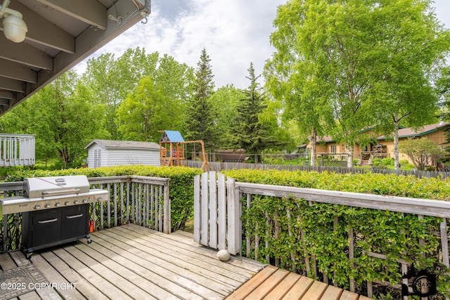 2100 N Palomino Ln, Palmer, AK 99645 - wooden terrace with a playground, a grill, and an outdoor structure