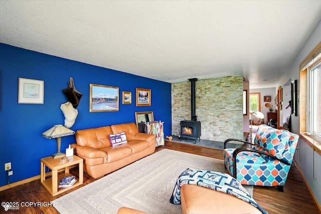 655 N Smith Rd, Palmer, AK 99645 - living area with a wood stove, wood finished floors, and baseboards