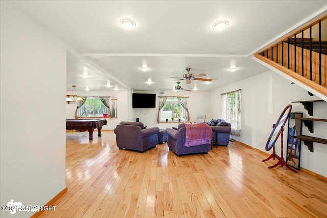 4588 Gold Mint Dr, Wasilla, AK 99654 - living area with light wood finished floors, stairway, billiards, ceiling fan, and baseboards