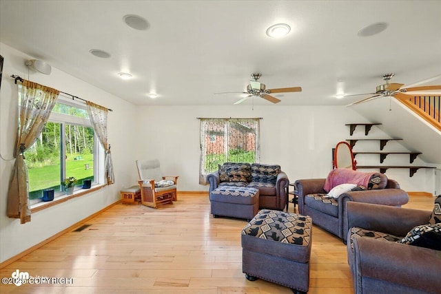 4588 Gold Mint Dr, Wasilla, AK 99654 - living area with a ceiling fan, light wood-type flooring, baseboards, vaulted ceiling, and stairway