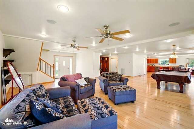 4588 Gold Mint Dr, Wasilla, AK 99654 - living room with stairway, light wood-type flooring, healthy amount of natural light, and billiards table