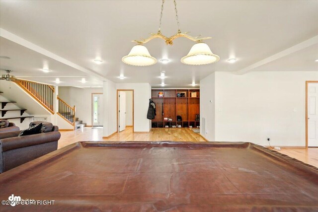 4588 Gold Mint Dr, Wasilla, AK 99654 - unfurnished living room featuring stairs, wood finished floors, and billiards table