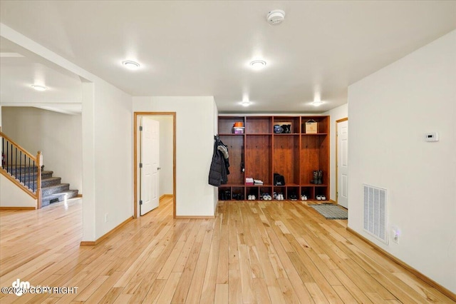 4588 Gold Mint Dr, Wasilla, AK 99654 - unfurnished room with light wood-style flooring, stairway, baseboards, and a smoke detector