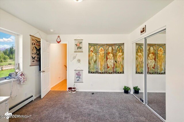 4588 Gold Mint Dr, Wasilla, AK 99654 - unfurnished bedroom with a baseboard radiator, carpet floors, and a closet